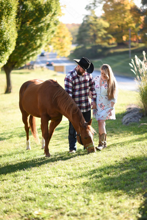 engaged-couple-walking-with-horse-sorrelwood-farms-2