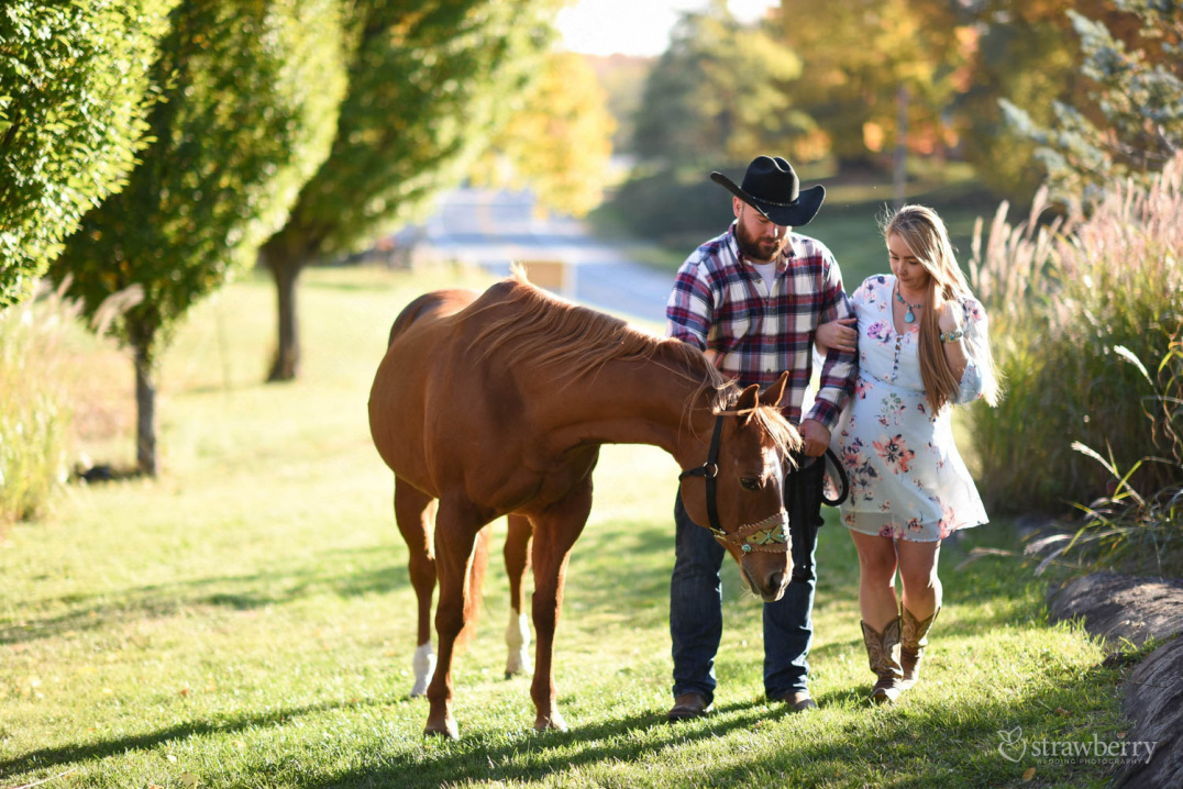 engaged-couple-walking-with-horse-sorrelwood-farms-3