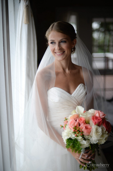 bride-with-wedding-bouquet-near-by-window