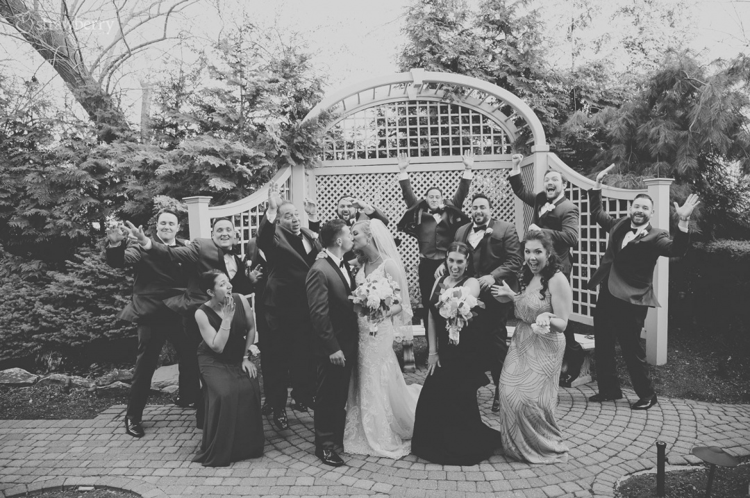 jump-group-photo-newlyweds-kiss-wedding-witness-park-bower