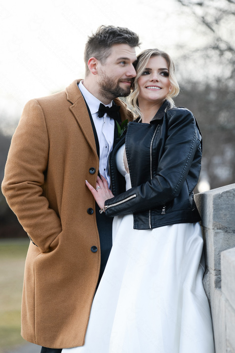 23-newlyweds-smile-wedding-black-leather-jacket